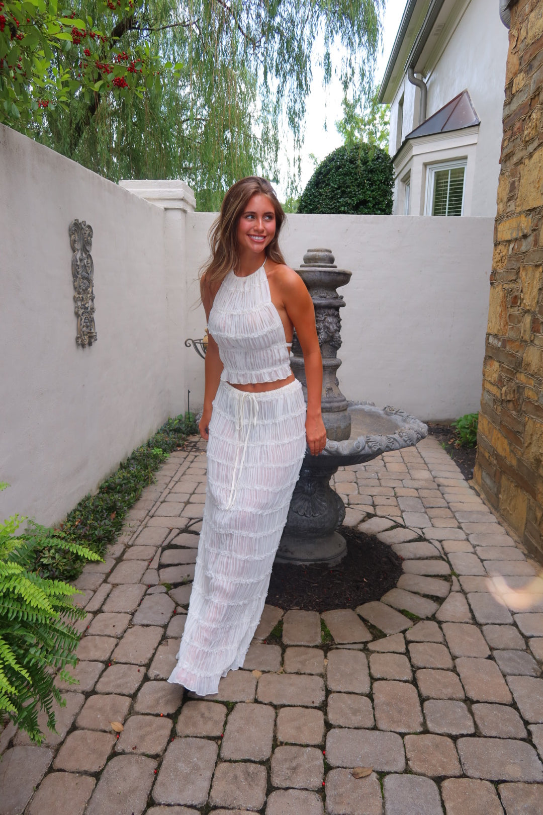 White Shannon Top by Strawberry Paris with pleated detailing and an open back.